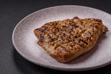 Grilled beef or pork steak with salt, spices and herbs