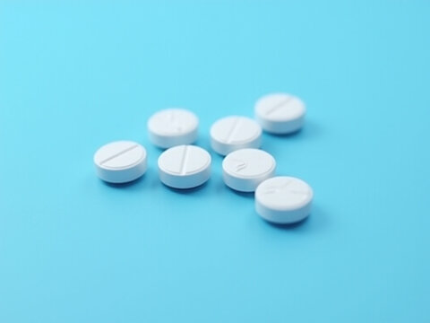 White pills on blue background