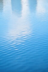 Naklejka premium Serene rippling water surface reflecting the sky