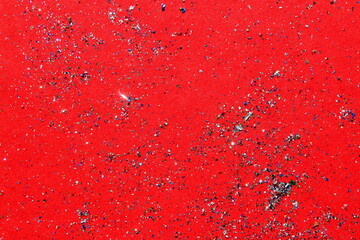 On the red background there are sparkles, blurred and out of focus.