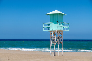 Light Blue Lifeguard Tower on Sandy Beach with Clear Sea