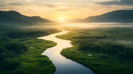 Fototapeta premium Quiet river meandering through a lush valley, with early morning mist gently rising from the water. The tranquil scene captures the serene beauty of nature in its peaceful, undisturbed state.