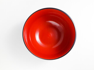 Empty red black plastic bowl isolated on white background