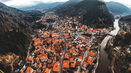 Panorama of an old European town with red rooftops and narrow streets.