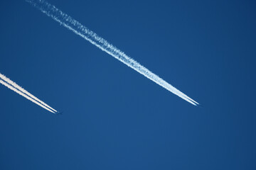 Airplane trails in the blue sky, contrails.