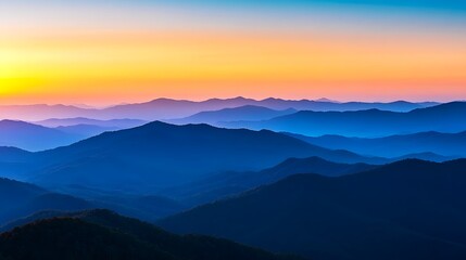 Fototapeta premium Sunrise over the mountains, with the early morning light illuminating the rugged peaks in a warm, golden glow