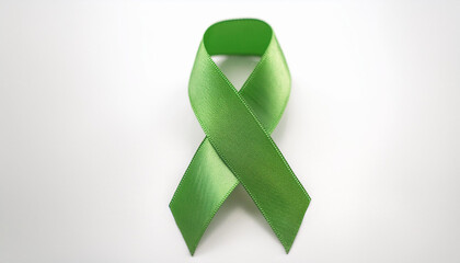 Green awareness ribbon on white backdrop. International symbol of mental health awareness.