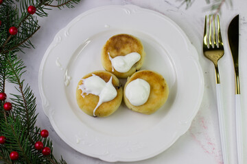 Apetite cheesecakes on a white plate. Christmas Breakfast