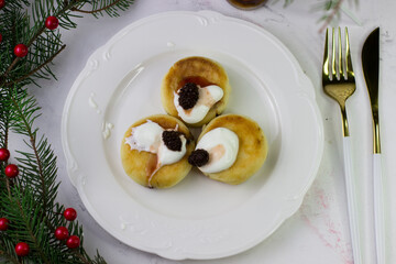 Apetite cheesecakes on a white plate. Christmas Breakfast