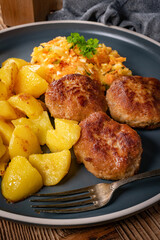 Meatballs  served with fired potatoes.