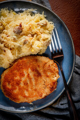 Minced meat cutlet with boiled sauerkraut.