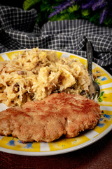Minced meat cutlet with boiled sauerkraut.