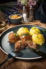 Meatballs with cheese served with boiled potatoes.