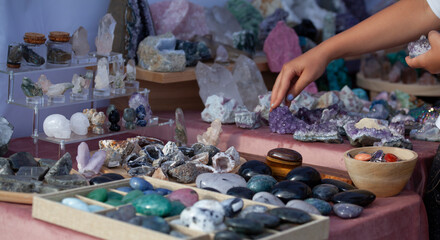 A market stall featuring crystals and precious gemstones like emeralds, sapphires, rubies,...