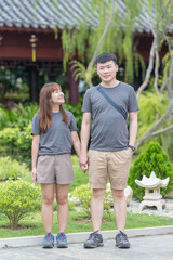 Fototapeta premium Chinese Malaysian couple in their 30s spending time in Chinese-style garden in Kuala Lumpur, Malaysia.