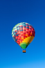 Kubicek Balloons Hot Air Balloon Soaring in Clear Blue Sky