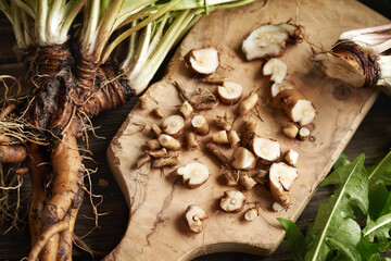 Cut up fresh dandelion root - preparation of herbal tincture