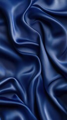 Obraz premium 深い青色のシルク生地が滑らかに広がり、光を反射して美しい質感を見せている様子