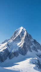 snowy mountain peak under a clear blue sky, majestic landscape, winter theme