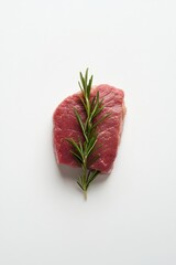 A raw piece of red meat garnished with fresh rosemary sprigs