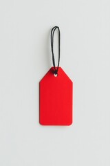 Red price tag hanging on white background