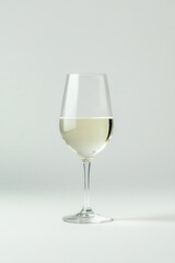 A glass of white wine on a light background