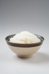 Freshly cooked white rice in a rustic ceramic bowl