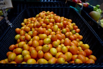 Vibrant crate of fresh citrus fruit, including lemons, limes, oranges, and mandarins.