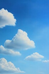 Obraz premium Fluffy white clouds against a bright blue sky