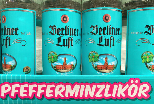 Viersen, Germany - November 5. 2024: Closeup of bottles german Berliner Luft peppermint liqueur in german store shelf (focus on central bottles)