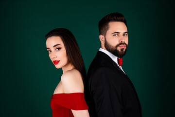 Photo of attractive young man woman couple stand backs dressed stylish fancy clothes isolated on green color background