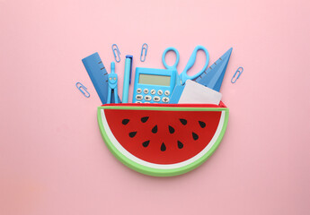 Stationery calculator ruler calculator and school cheat sheets on coloured background. Concept of...