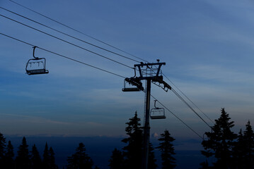 Empty chair lift for skiers and snowboarders - ski lift in the afternoon