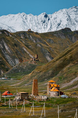 Abano village in Truso Valley, Georgia: stunning alpine scenery with snow-capped peaks, colorful meadows, and winding rivers under a clear blue sky