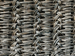 A rustic old fence texture made from natural materials. The old fence crafted from woven branches.