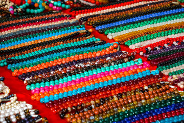 Closeup view of indian traditional handicraft (bracelets) on the street market, Arambol, Goa, India.