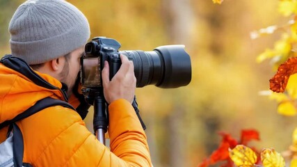 A photographer in a bright orange jacket focuses on capturing the striking fall foliage in a beautiful forest landscape