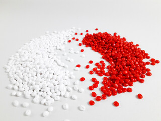 Red and white masterbatch granules isolated on white background.Color pigment carrier polymer in plastics industry