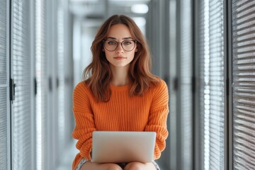 A woman sits in a corridor of data servers with a laptop, representing the intersection of human intellect and digital technology in a serene environment.