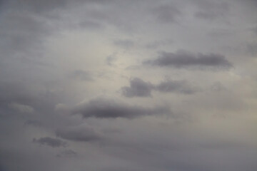 Fototapeta premium Altostratus clouds - a dense veil of grayish hue, with white or gray tufts spread across the sky