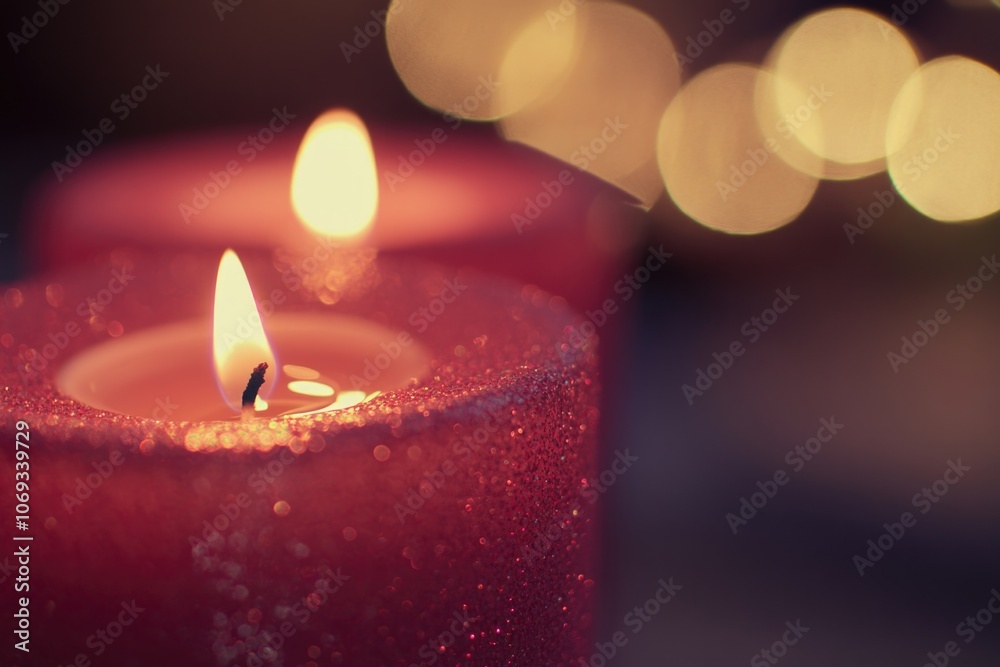 Poster a single red candle on a darkened background, perfect for use as a symbol of remembrance or to add d