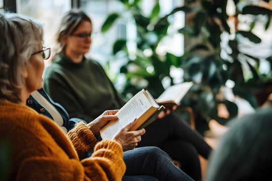 Participants relax with books in a bright, plant-filled room during a peaceful reading session