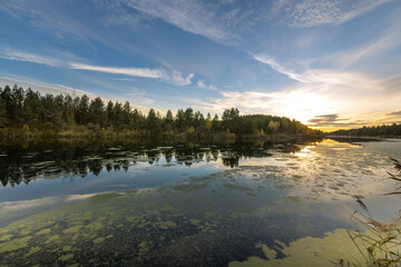 A lake with a cloudy sky in the background