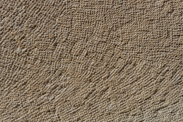 Wall with a rough texture and a pattern of lines