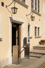 The payment turnstile for paid toilets access. A modern automatic ticket reading machine stands at museum entrance outdoors