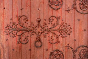 Detail of the red wooden entrance door to the basilica of Vézelay in Burgundy, France