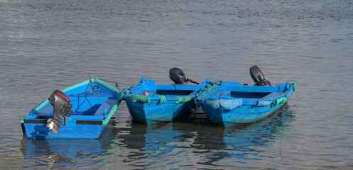 Three Small Blue Tenders Boats Moored in the Bay