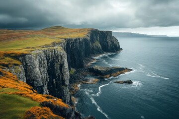 Majestic cliffs encircling a tranquil bay under dramatic and moody overcast skies