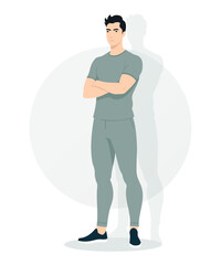 Young man in gray t-shirt and sweatpants in a relaxed pose with closed hands. Simple and comfortable style, suitable for everyday use and outdoor activities.