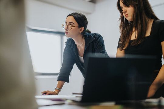 Focused and engaged students working together on a school project. The teamwork and collaboration highlights their dedication and enthusiasm for learning in an academic environment.